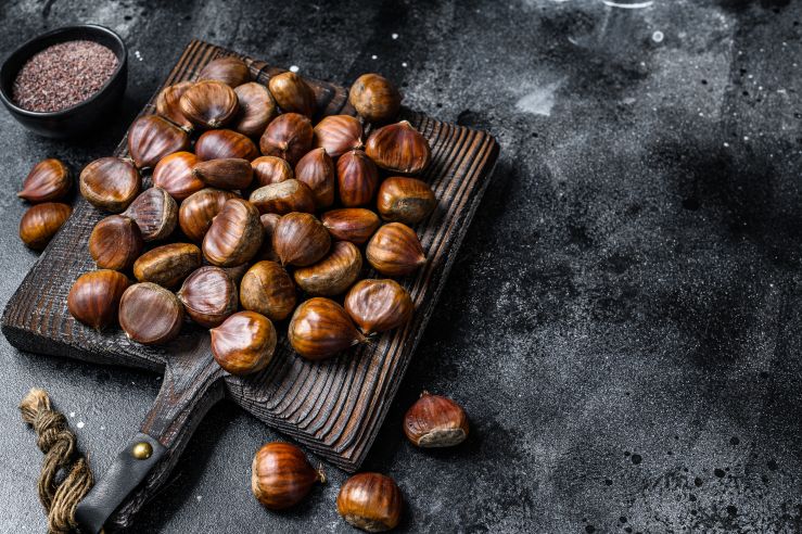 raw-chestnuts-on-a-wooden-cutting-board-black-bac-2021-10-21-02-49-20-utc.JPG