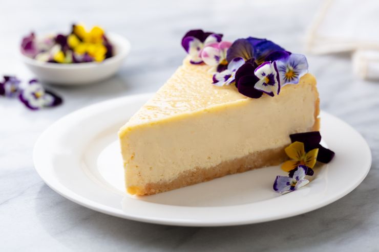 cheesecake-decorated-with-edible-flowers-on-white-2021-08-31-21-38-42-utc.jpg
