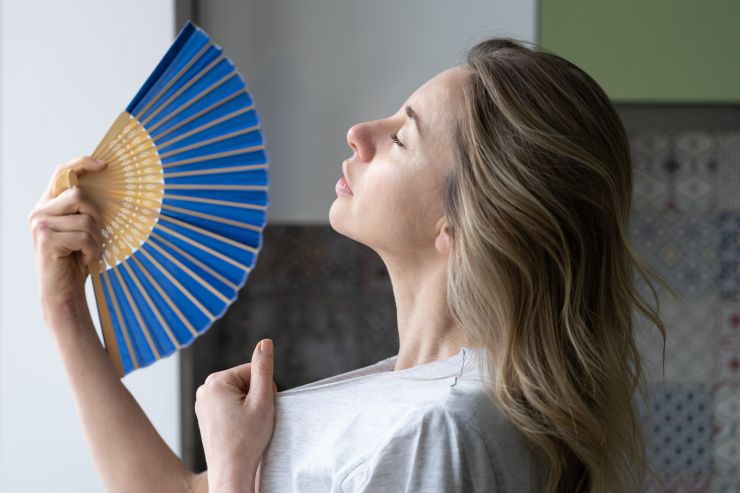 overheated-woman-in-t-shirt-using-wave-fan-suffer-2021-08-31-11-06-37-utc.jpg